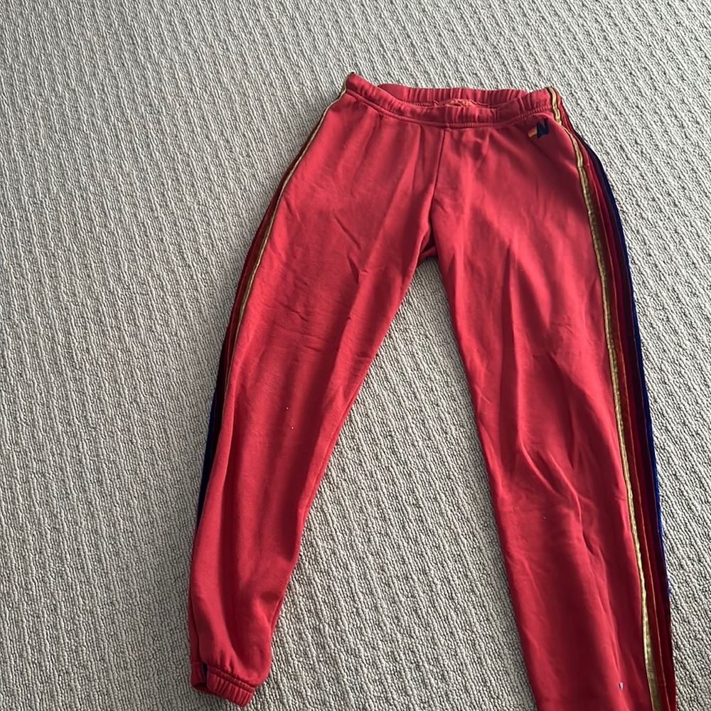 Red aviator nation sweatpants with velour striping down side